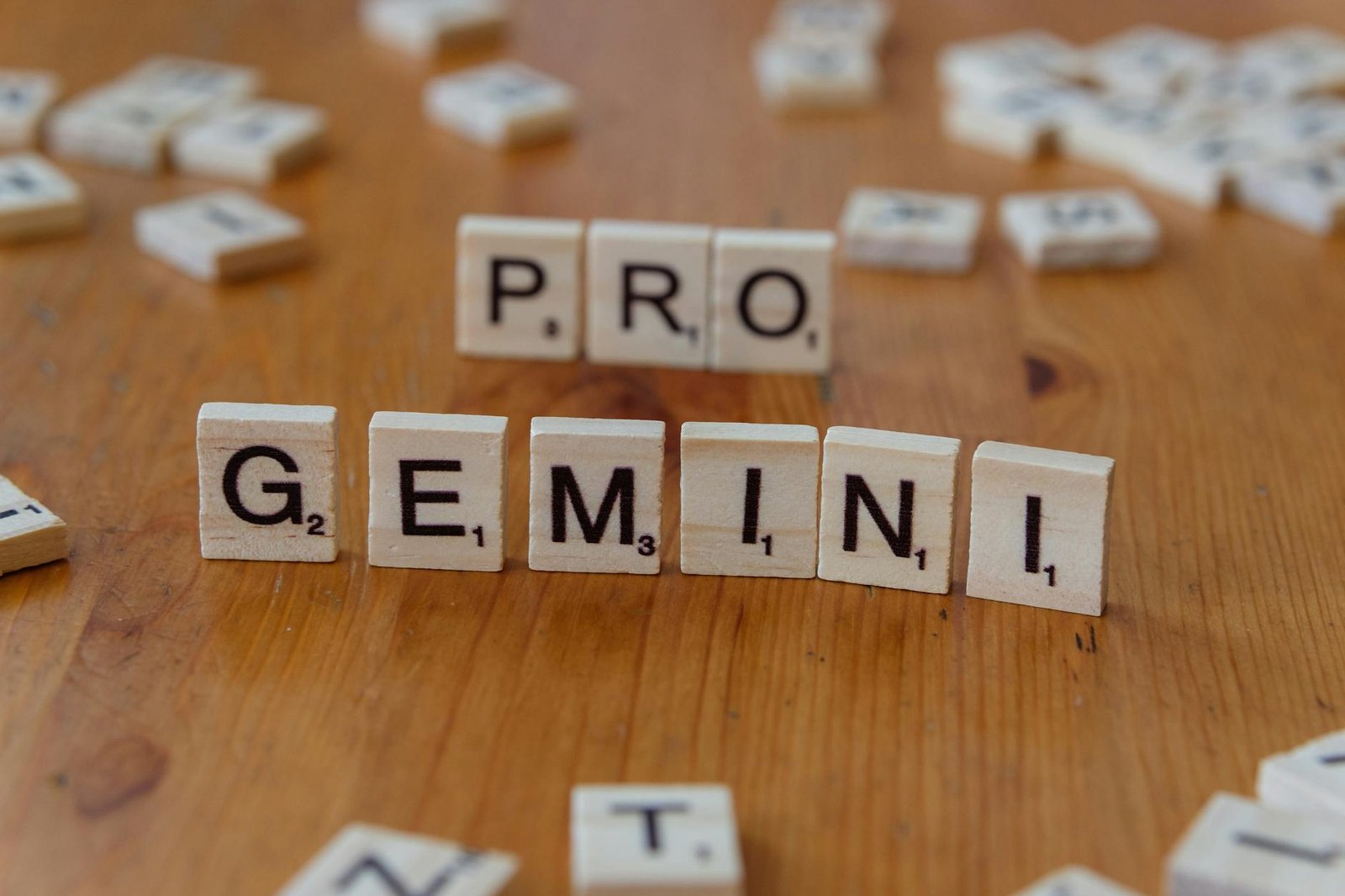 scrabble tiles spelling pro gemini on wooden table